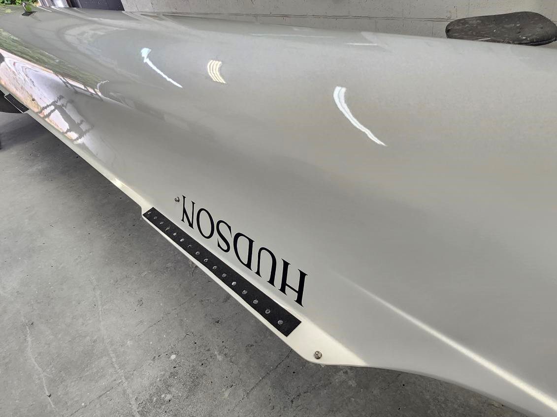 Close-up of a white car with the 'Hudson' emblem.