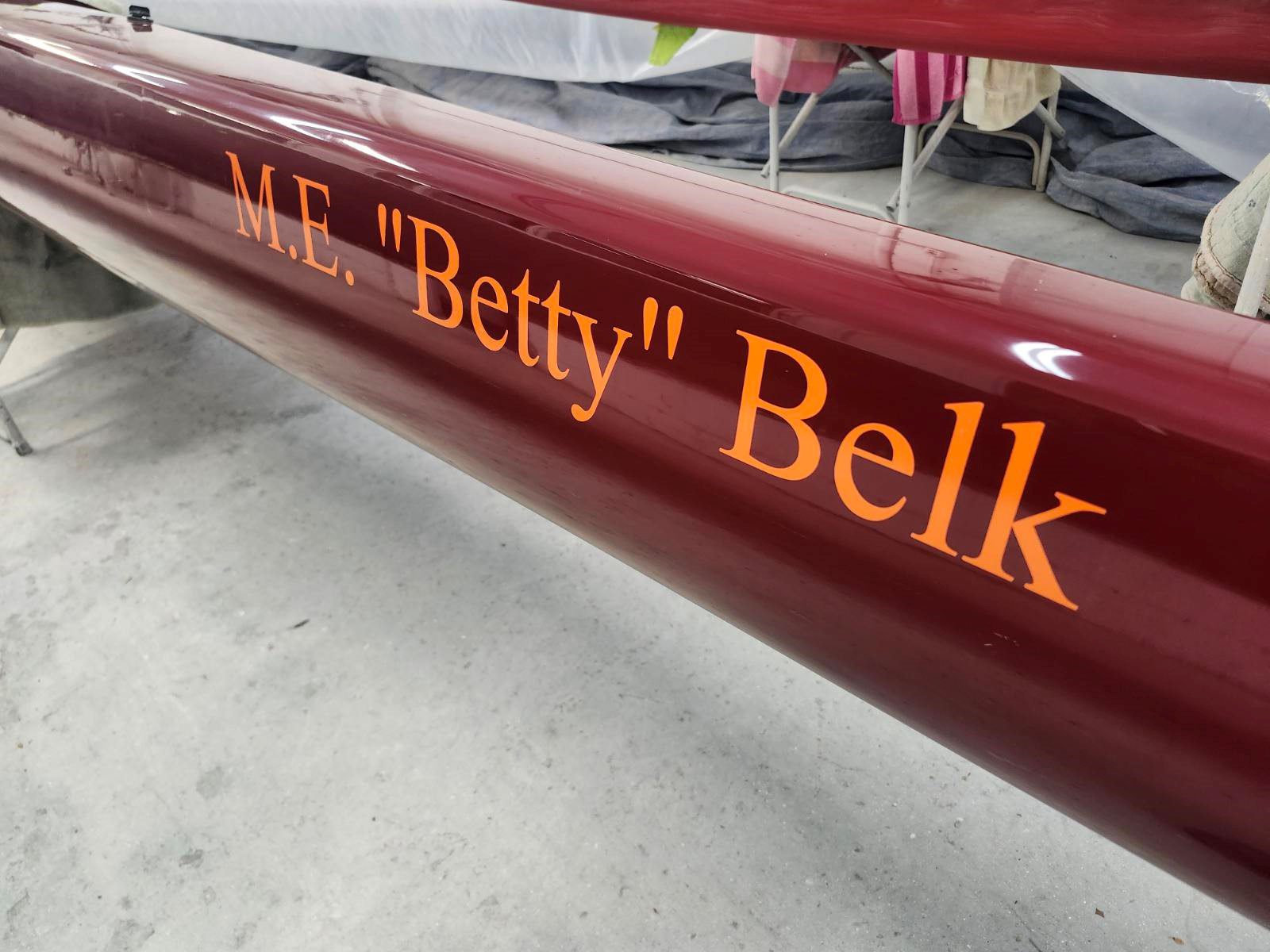 Close-up of a red boat named 'Betty Belk' with polished lettering.