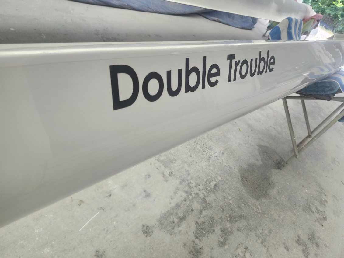 Close-up of an object labeled 'Double Trouble' in a workshop.