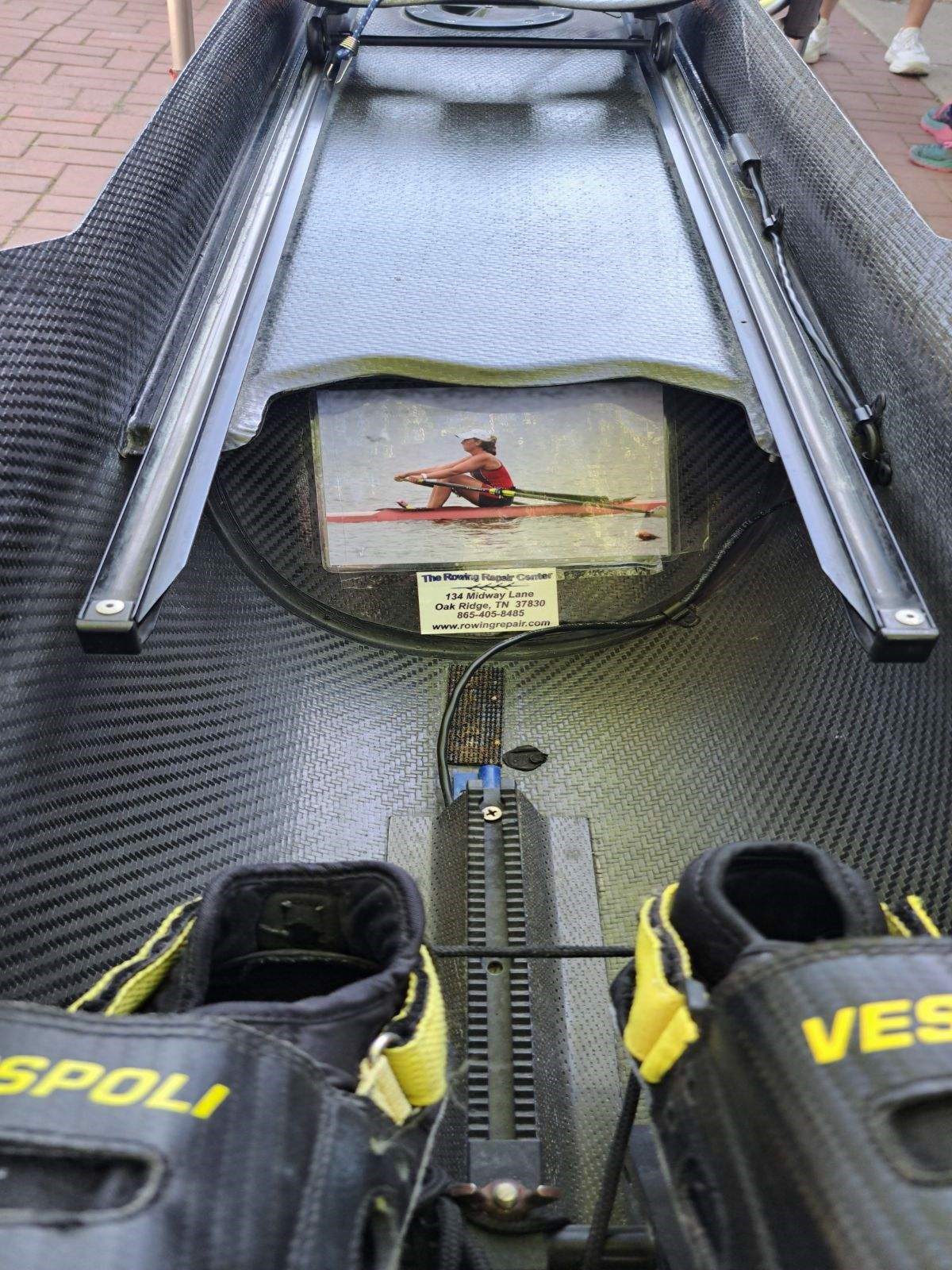A hockey helmet with a photo taped inside and gloves nearby.