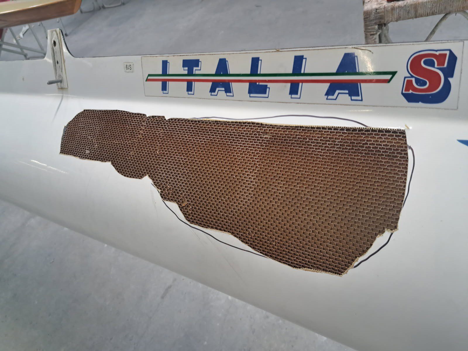 A piece of textured fabric beside a ruler marked 'ITALIA'.