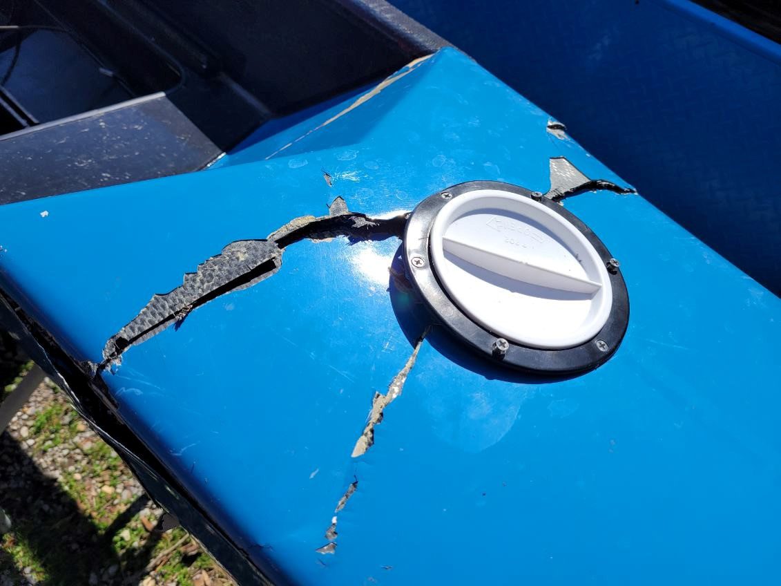 Close-up of a blue surface with a silver round object and rust marks.