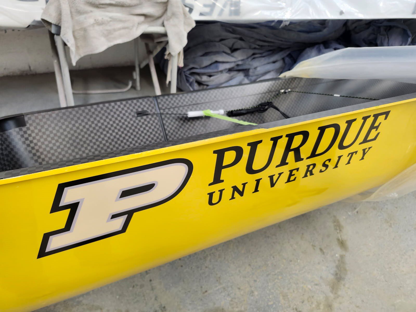 Yellow Purdue University kayak with large 'P' logo.