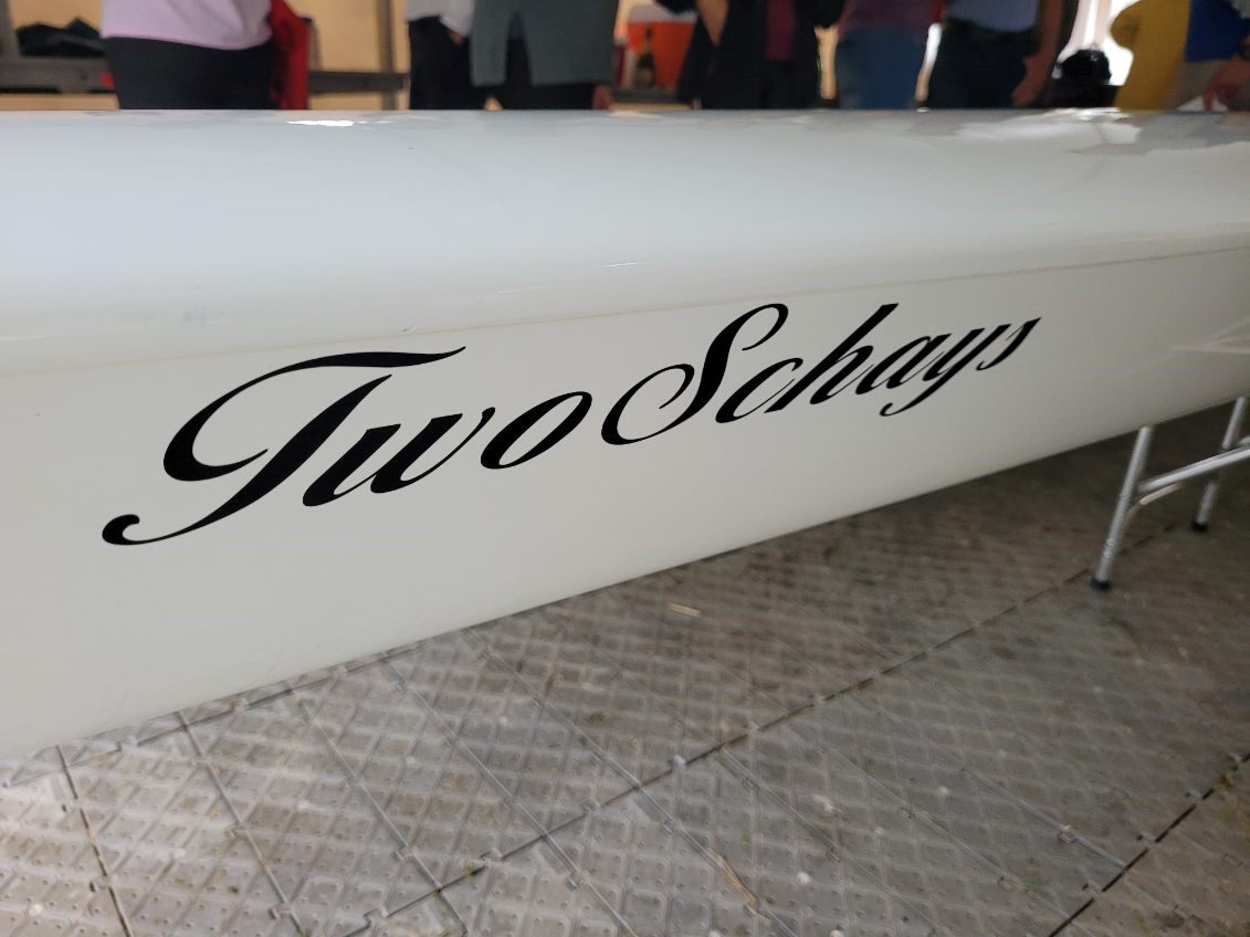 Close-up of a white object with the word 'TwoSchay' in cursive.