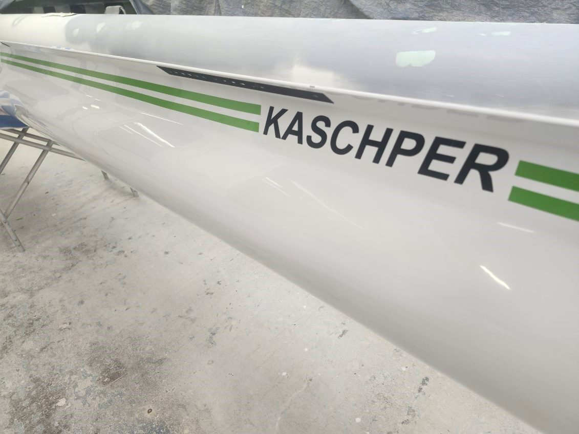 Close-up of a white aircraft wing with the name 'KASCHPER' on it.