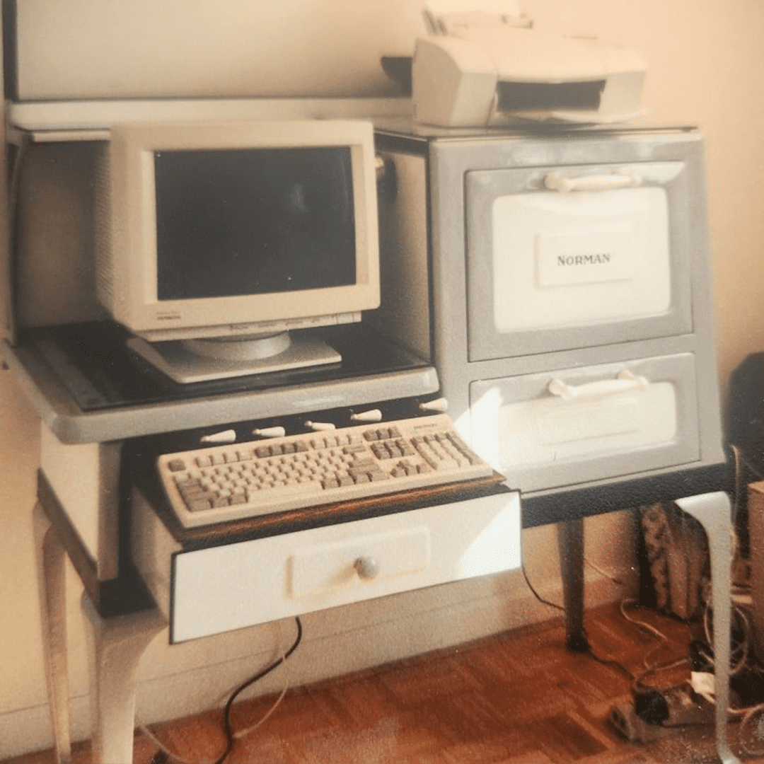 Vintage computer setup with CRT monitor and dot matrix printer on a desk.