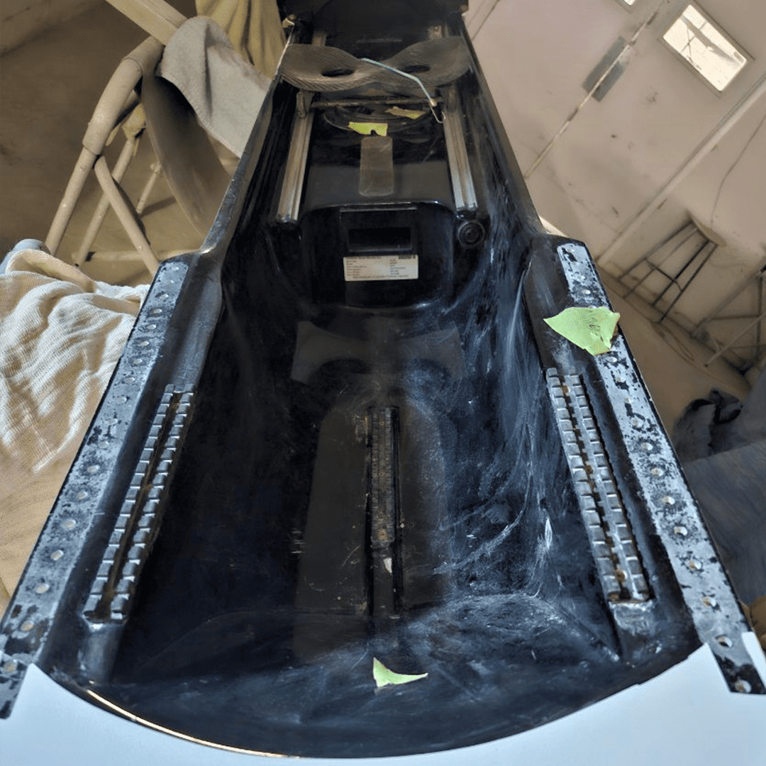 Close-up of a car roof with a sunroof assembly and exposed interior.