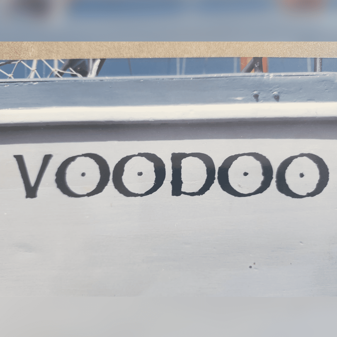 The word 'VOODOO' painted on a white surface.