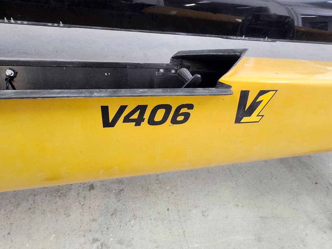 Close-up of a yellow object with black text 'V406' and a black symbol.
