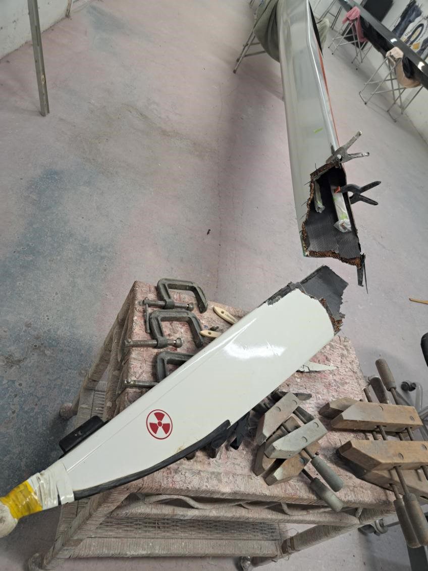 Chainsaw resting on bricks in a workshop.