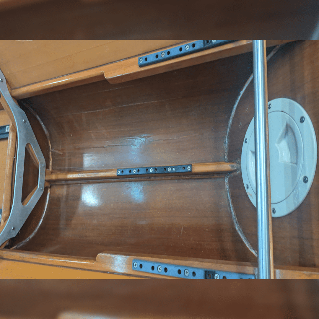 Interior of a wooden boat showing structural components and fittings.